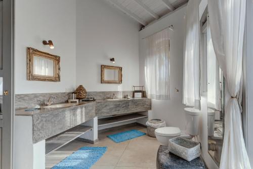a bathroom with a large marble sink and a toilet at Bellini Blue in Unawatuna