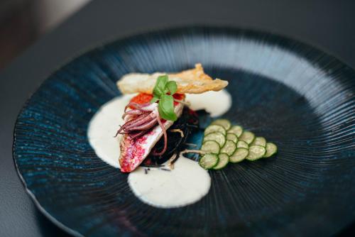 a blue plate with food on a table at Hotel FRANQ in Antwerp