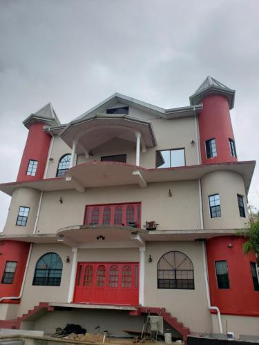 a building with red doors and red windows at CASTLE VIEW VILLA in Diamond
