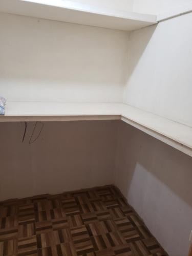 a room with a white shelf and a wooden floor at CASTLE VIEW VILLA in Diamond
