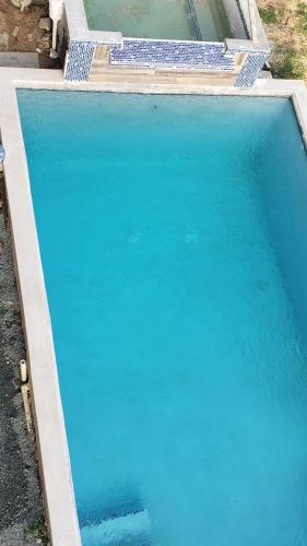 a large pool of blue water in a yard at CASTLE VIEW VILLA in Diamond