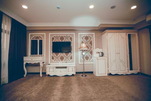 a living room with a television and a table at Baku Hotel Ganja in Ganja