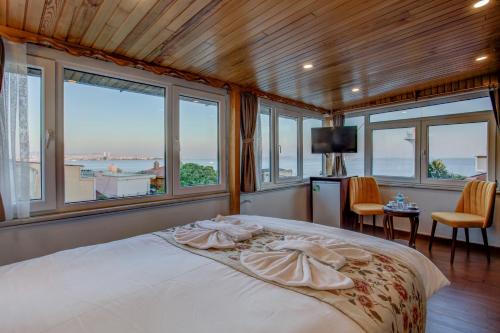 a bedroom with a large bed with windows at Violin Hotel Sultanahmet in Istanbul