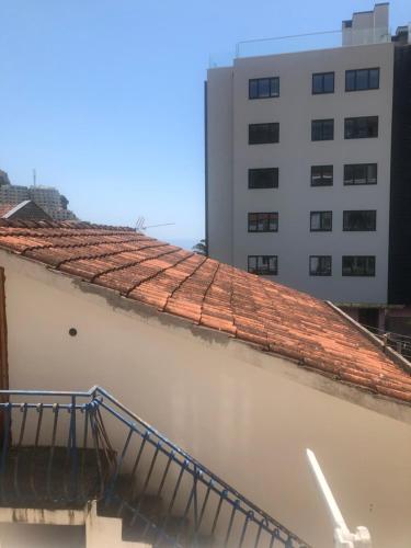 a tile roof on a building with a building at Apartments Djuro Rafailovic in Budva