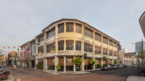 a large building on a city street with cars parked at Campbell House in George Town