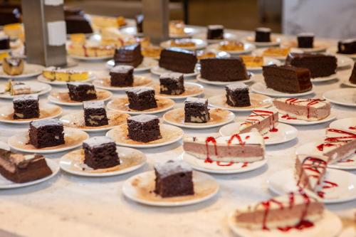 a table with many different types of cakes on plates at RVHotels Tuca in Vielha