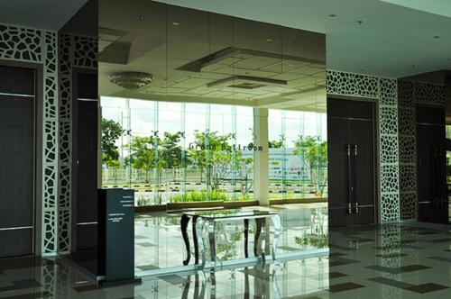 a lobby with a glass table in a building at Raia Hotel & Convention Centre Alor Setar in Alor Setar