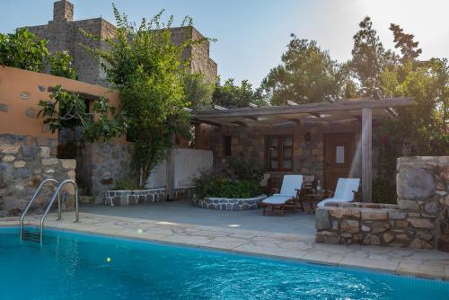 a house with a swimming pool and a patio at Blue Vista Patmos pool studio in Patmos