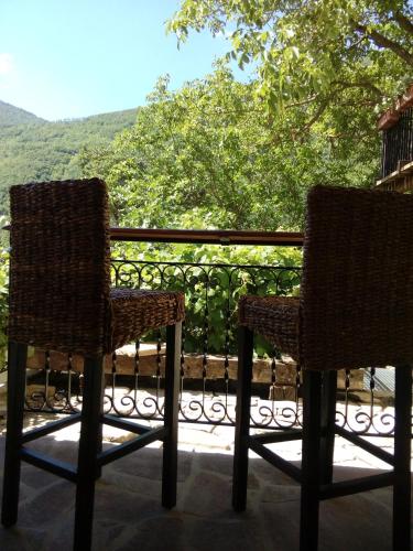 two chairs sitting on top of a balcony with a view at Bed & Breakfast SENTIERO 54 in Cantiano