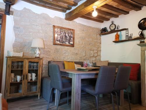 a dining room with a wooden table and chairs at Bed & Breakfast SENTIERO 54 in Cantiano