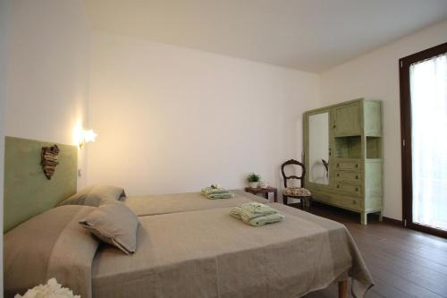 a bedroom with a bed and a dresser and a mirror at Il RosAle a Celle Ligure in Celle Ligure