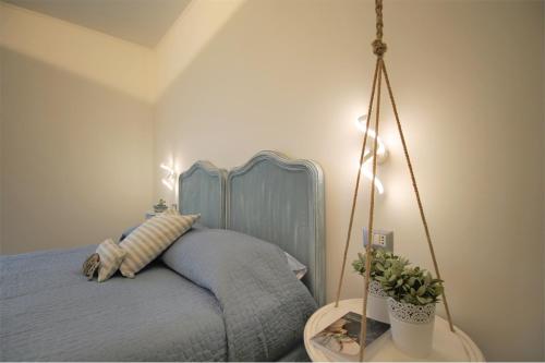 a bedroom with a blue bed with a swing at Il RosAle a Celle Ligure in Celle Ligure