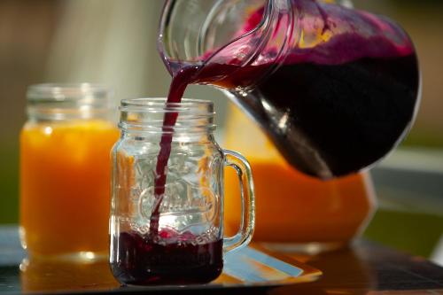 a person pouring a flower into a glass jar at Saciova Hills in Saciova