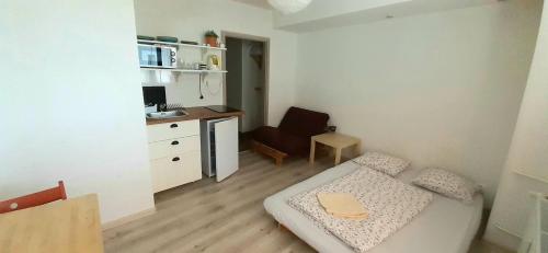 a small room with a bed and a desk at Apartments Pod Kotlom in Vysoké Tatry