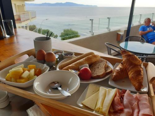 a tray of breakfast foods on a table with a view at Rallye Hotel in L'Escala
