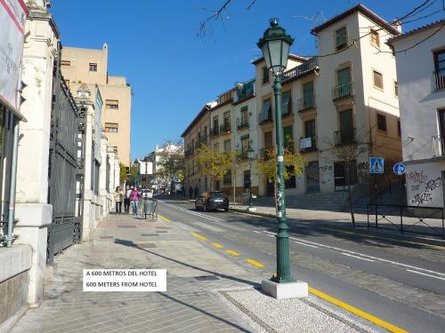 a street scene with a street light and buildings at Abadía Hotel in Granada