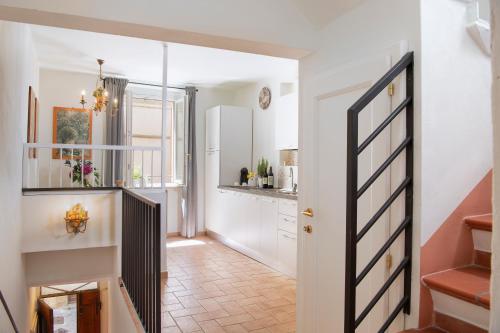 a hallway of a home with a staircase and a kitchen at Scacciapensieri Guest House in Arezzo