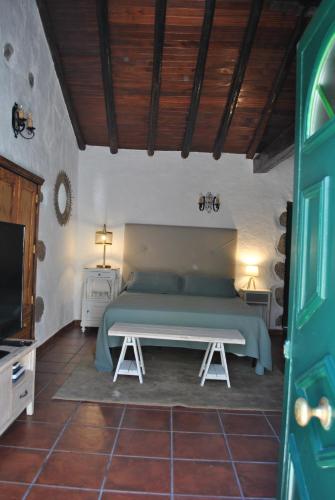a bedroom with a bed and a tv in it at RK La Casona de Tejeda in Tejeda