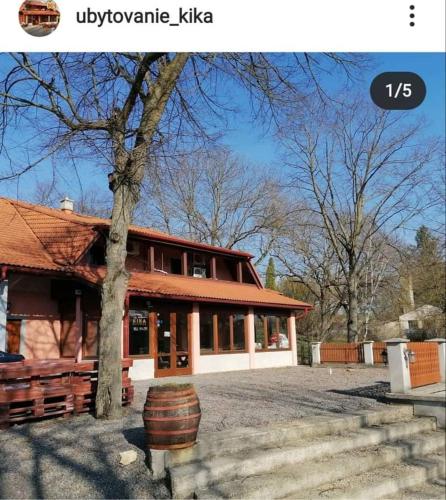 a house with a barrel in front of it at Ubytovanie na súkromí KIKA in Santovka