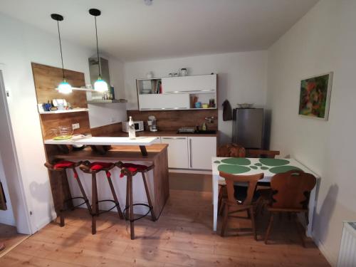 a kitchen with a table and two chairs and a table and a kitchen with at Im Herzen des Kraichgaus 1 in Östringen