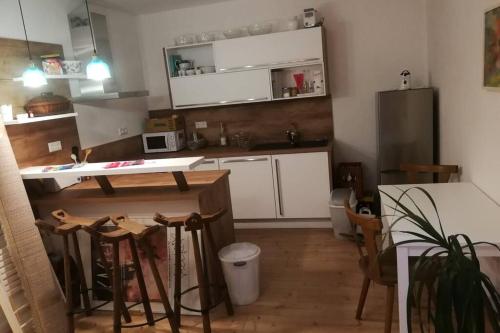 a kitchen with white cabinets and a table and chairs at Im Herzen des Kraichgaus 1 in Östringen