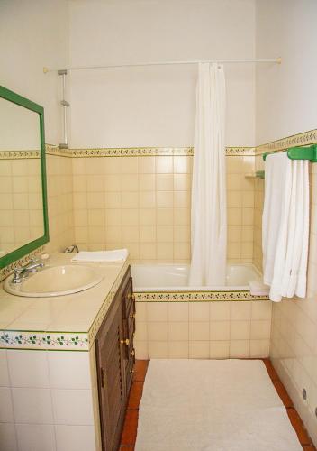 a bathroom with a sink and a tub and a shower at Casa da Quinta do Outeiro in Viana do Castelo