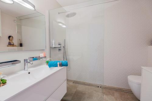 une salle de bain blanche avec une douche et un lavabo dans l'établissement LE FRANCIA II AP4197 By RIVIERA HOLIDAY HOMES, à Nice