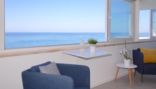 a living room with a view of the ocean at Paradise Quarteira in Quarteira