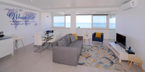 a living room with a couch and a tv at Paradise Quarteira in Quarteira
