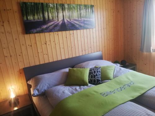 a bedroom with a bed with a blanket on it at Billenberghof in St. Gallen