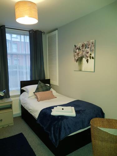 a bedroom with a bed with a tray on it at Spacious & Cozy Mid Wales Town Centre Apartment, With Bike Storage in Llandrindod Wells