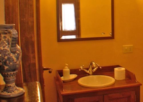 a bathroom with a sink and a mirror at Relais Villa Giusso in Vico Equense