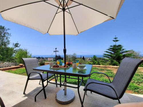 a table with an umbrella on a patio at Freesia Grand Sea View Residence in Sarlata