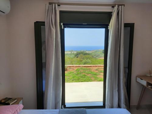 a bedroom with a window with a view at Freesia Grand Sea View Residence in Sarlata