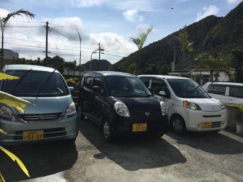 a group of three cars parked in a parking lot at STAY IN ALOHA in Tokashiki