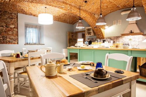 a dining room with a wooden table and chairs at Agr. Cascina Fabbrica in Fossano