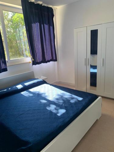 a bedroom with a large bed with a window at Portorosa in Torre Forte