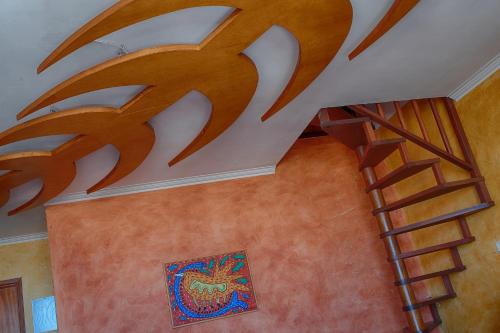 a spiral staircase in a house with a painting on the ceiling at House In Aguda Beach, praia da Aguda, in Aguda
