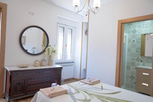 a bathroom with a mirror and a sink and a shower at Pensión Casa do Gallo Sarria in Sarria