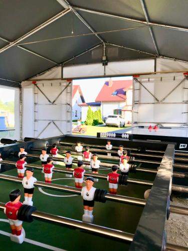 a group of toy men playing a game of ping pong at Resto domki letniskowe in Sarbinowo