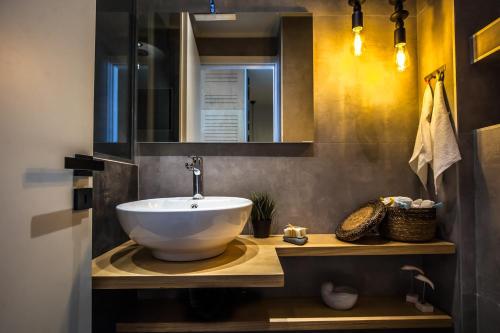 a bathroom with a large white bowl sink on a counter at Bella Casa in Stalida