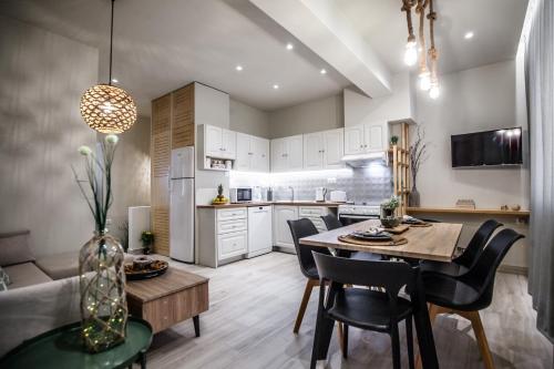 a kitchen and dining room with a table and chairs at Bella Casa in Stalida