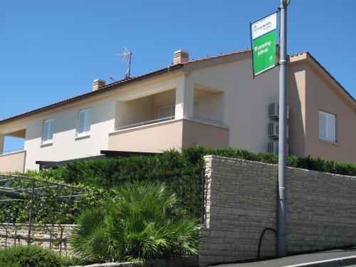 a building with a street sign in front of it at Apartments Mia Krk in Krk