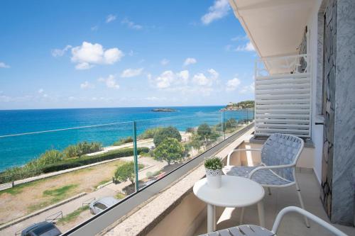 a balcony with a table and chairs and the ocean at Hotel Calanca in Marina di Camerota