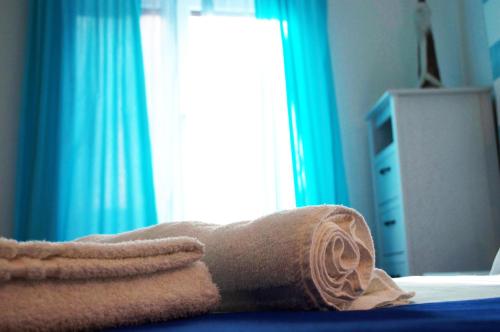 a towel laying on a bed in front of a window at Giramondo in Rapallo