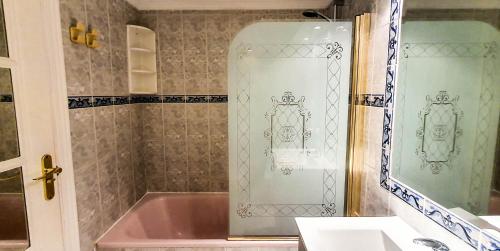a bathroom with a pink tub and a mirror at Skol 708 Fantastic 2 Bedroom Apartment For Holiday Rentals in Marbella