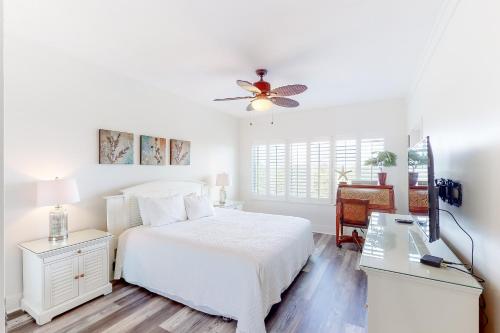 a white bedroom with a bed and a ceiling fan at Gulf View from the Summit at Tops'l Beach Resort in Destin