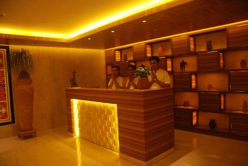 a group of people standing at a bar at The Lalit Great Eastern Kolkata in Kolkata