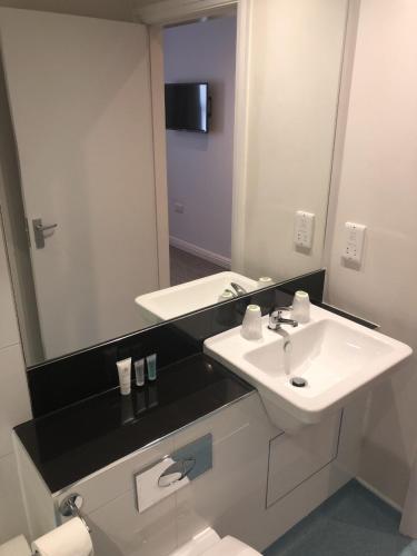 a bathroom with a sink and a mirror at Best Western Lancaster Morecambe Lothersdale Hotel in Morecambe