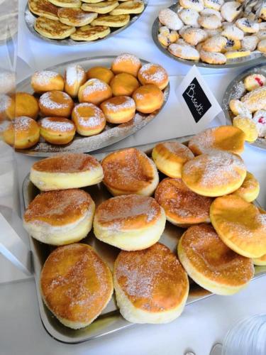 a display of donuts and other pastries in a bakery at Golf & Beach Hotel in Milano Marittima